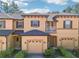 Two-story townhouse with attached garage, balcony, and appealing exterior finishes at 2020 Retreat View Cir, Sanford, FL 32771