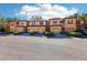 Row of tan townhomes with attached garages and neatly landscaped yards at 2020 Retreat View Cir, Sanford, FL 32771