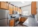 L-shaped kitchen with stainless steel appliances and wood cabinets at 2020 Retreat View Cir, Sanford, FL 32771