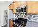 Stainless steel appliances and wood cabinets in this kitchen at 2020 Retreat View Cir, Sanford, FL 32771