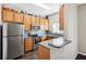 L-shaped kitchen with stainless steel appliances and wood cabinets at 2020 Retreat View Cir, Sanford, FL 32771