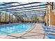 Refreshing community pool, screened enclosure, and plentiful lounge chairs at 2020 Retreat View Cir, Sanford, FL 32771