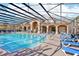 Relaxing community pool with screen enclosure and comfortable lounge chairs at 2020 Retreat View Cir, Sanford, FL 32771
