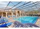 Inviting community pool with screened enclosure and ample lounge chairs at 2020 Retreat View Cir, Sanford, FL 32771