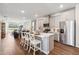 Open kitchen with island, stainless steel appliances, and view of living room at 2615 Kinsale Ln, Ormond Beach, FL 32174