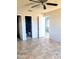Bedroom with tile floors, ceiling fan, and bathroom access at 1096 E Lombardy Dr, Deltona, FL 32725