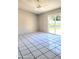 Living room with tile floors and sliding glass doors to the backyard at 1096 E Lombardy Dr, Deltona, FL 32725