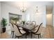 Dining room featuring elegant chandelier lighting, a stylish dining table, and decorative rug at 1116 W Riviera Blvd, Oviedo, FL 32765