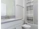 Simple bathroom with a shower/tub combo and white vanity at 1593 Mulligan Blvd, Davenport, FL 33896