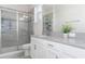 Bathroom with double vanity, gray countertop, and walk-in shower at 1593 Mulligan Blvd, Davenport, FL 33896