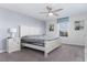 Spacious bedroom with a large bed, nightstand, and ceiling fan at 1593 Mulligan Blvd, Davenport, FL 33896