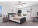 Bedroom with a gray upholstered bed and a workspace at 1593 Mulligan Blvd, Davenport, FL 33896