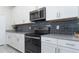 Modern kitchen with white cabinets and stainless steel appliances at 1593 Mulligan Blvd, Davenport, FL 33896