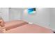 Two twin beds in a bedroom with large TV and window at 2561 Montego Bay Blvd, Kissimmee, FL 34746
