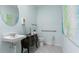 Small bathroom with white sink, dark vanity, and accessible features at 308 Corso Loop, Winter Haven, FL 33884