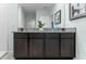 Double vanity bathroom with granite countertops and dark wood cabinets at 308 Corso Loop, Winter Haven, FL 33884