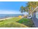 Lakefront backyard with grassy area and patio seating at 3420 Lake Harney Cir, Geneva, FL 32732