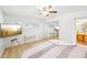 Bright bedroom with a comfortable bed, built-in mirrored closet, and a large TV at 3420 Lake Harney Cir, Geneva, FL 32732