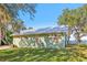 Green house exterior with a metal roof and a large grassy yard at 3420 Lake Harney Cir, Geneva, FL 32732