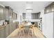 Modern kitchen with gray cabinets, island, and stainless steel appliances at 3420 Lake Harney Cir, Geneva, FL 32732
