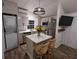 Modern kitchen with white cabinets, stainless steel appliances & breakfast bar at 3420 Lake Harney Cir, Geneva, FL 32732
