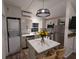 Modern kitchen features white cabinets, stainless steel appliances, and a kitchen island at 3420 Lake Harney Cir, Geneva, FL 32732