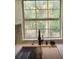 Modern kitchen sink with a black gooseneck faucet and large window at 3420 Lake Harney Cir, Geneva, FL 32732