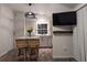 Open concept kitchen boasts white cabinets, a kitchen island, and a mounted TV at 3420 Lake Harney Cir, Geneva, FL 32732