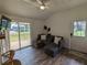 Living room features a gray sectional sofa and sliding glass doors to deck at 3420 Lake Harney Cir, Geneva, FL 32732