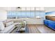 Bright sunroom with water views, comfortable seating, and a large TV at 3420 Lake Harney Cir, Geneva, FL 32732