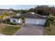 Aerial view of a single-story house with a two-car garage and solar panels at 402 Blue Lake Cir, Kissimmee, FL 34758