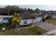 Aerial view of a two-story house with a paved driveway and landscaping at 402 Blue Lake Cir, Kissimmee, FL 34758