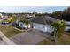 Aerial view of a single-story house with a two-car garage and solar panels at 402 Blue Lake Cir, Kissimmee, FL 34758