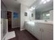 Double vanity bathroom with modern white cabinets and a large mirror at 402 Blue Lake Cir, Kissimmee, FL 34758