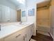Clean and modern bathroom with white vanity, tub and dark wood floors at 402 Blue Lake Cir, Kissimmee, FL 34758