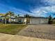 Two-story house with a three-car garage and well-manicured lawn at 402 Blue Lake Cir, Kissimmee, FL 34758