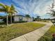 Single story home with a two-car garage and lush green lawn at 402 Blue Lake Cir, Kissimmee, FL 34758