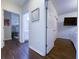 Hallway with dark hardwood floors and doors to bedrooms and a bathroom at 402 Blue Lake Cir, Kissimmee, FL 34758