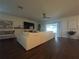 Bright living room featuring a large sectional sofa and sliding glass doors at 402 Blue Lake Cir, Kissimmee, FL 34758