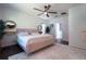 Serene main bedroom featuring a pink upholstered bed and ensuite bathroom access at 402 Blue Lake Cir, Kissimmee, FL 34758