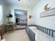 bedroom with a crib, high chair, and view of Primary bedroom at 402 Blue Lake Cir, Kissimmee, FL 34758