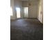 Living room with neutral carpeting and sliding glass doors at 413 Summit Ridge Pl # 305, Longwood, FL 32779