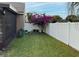Landscaped backyard with lush greenery and white fence at 553 Whittingham Pl, Lake Mary, FL 32746