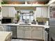 Well-equipped kitchen with white cabinets and granite counters at 553 Whittingham Pl, Lake Mary, FL 32746