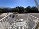 Small balcony with table and chairs overlooking a pond and neighborhood at 556 Lake Wildmere Cv, Longwood, FL 32750