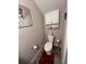 Small half bathroom with white toilet and vanity at 556 Lake Wildmere Cv, Longwood, FL 32750