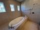 Relax in this spa-like bathroom, featuring a large soaking tub and shower at 556 Lake Wildmere Cv, Longwood, FL 32750