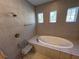 Bathroom with soaking tub and shower at 556 Lake Wildmere Cv, Longwood, FL 32750