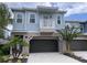 Two-story light blue house with dark brown garage door and balcony at 556 Lake Wildmere Cv, Longwood, FL 32750