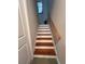 Staircase with light wood treads and white risers at 556 Lake Wildmere Cv, Longwood, FL 32750